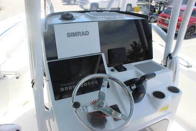 Slide: The Image of The image shows the helm of a 2023 Sea Pro 219 Center Console boat with Simrad electronics. - 15