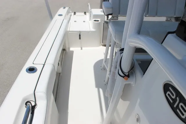 Slide: The Image of The image shows the cockpit of a 2023 Sea Pro 219 Center Console boat with white upholstery. - 33