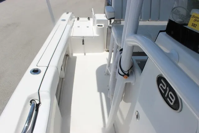 Slide: The Image of The image shows the deck of a 2023 Sea Pro 219 Center Console boat with white surfaces. - 19