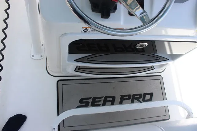 Slide: The Image of The image shows the helm of a 2023 Sea Pro 219 Center Console boat. - 14