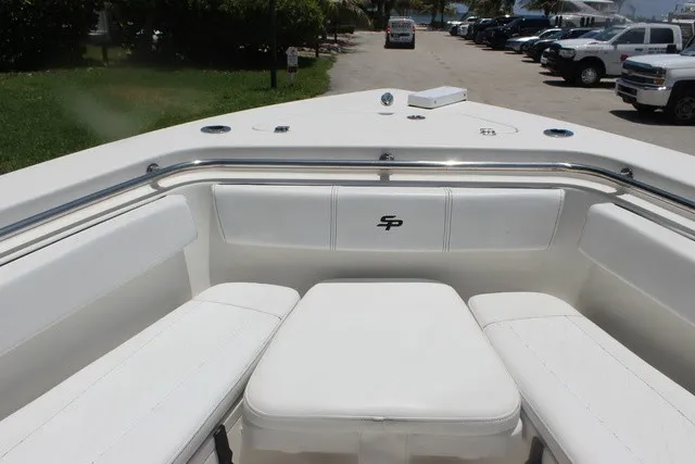 Slide: The Image of The image shows the bow of a 2023 Sea Pro 219 Center Console boat with white upholstery. - 26