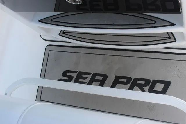 Slide: The Image of Close-up of the floor on a Sea Pro 219 Center Console boat featuring the brand logo. - 42