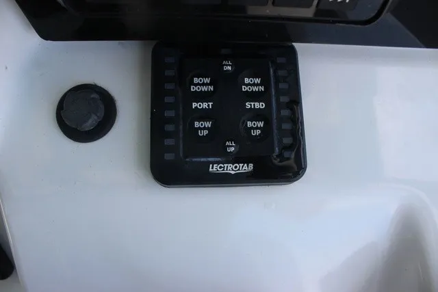 Slide: The Image of Close-up of a control panel with buttons for trim tab adjustments. - 39