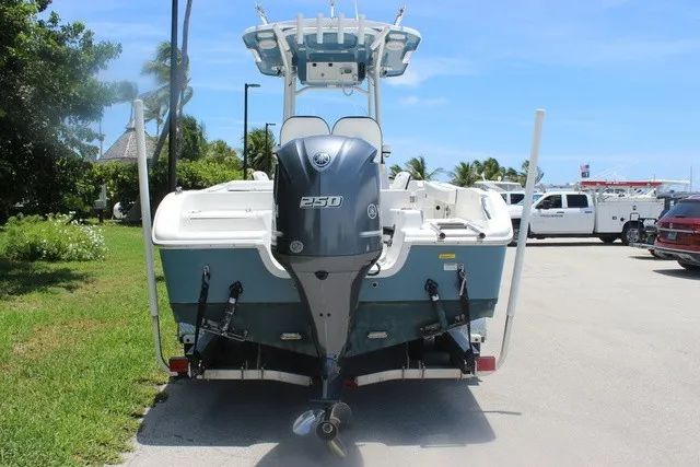 Slide: The Image of Rear view of a Sea Pro 219 Center Console boat with a 250 HP outboard motor, parked in a lot. - 6