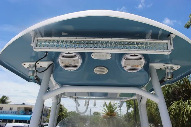 Slide: The Image of The image shows the T-top of a Sea Pro 219 Center Console boat with lights and speakers. - 35