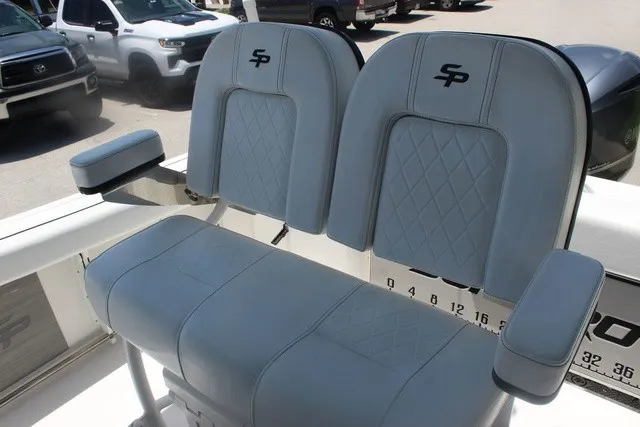 Slide: The Image of The 2023 Sea Pro 219 Center Console features cushioned seats with armrests and a quilted pattern. - 13
