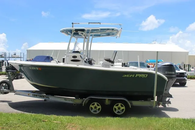 Slide: The Image of A 2023 Sea Pro 219 Center Console boat on a trailer, featuring a Yamaha outboard motor. - 5