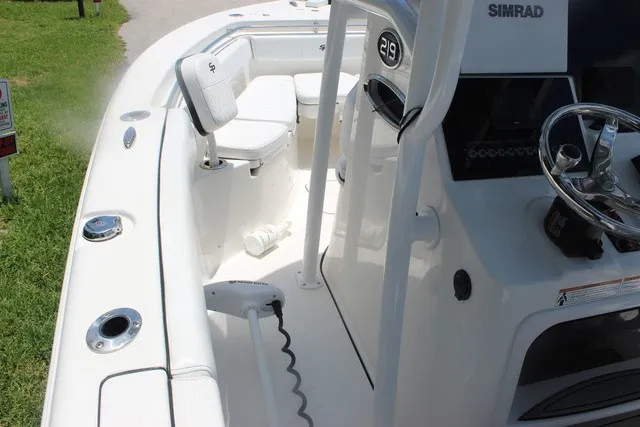 Slide: The Image of The image shows the cockpit of a 2023 Sea Pro 219 Center Console boat with helm and seating area. - 16