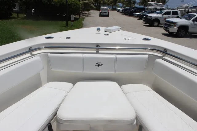 Slide: The Image of The image shows the bow of a 2023 Sea Pro 219 Center Console boat with white cushions. - 27