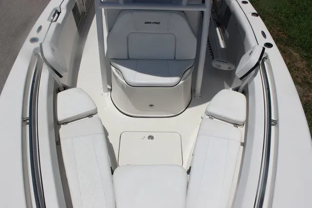 Slide: The Image of The image shows the bow area of a 2023 Sea Pro 219 Center Console boat with white upholstery. - 29