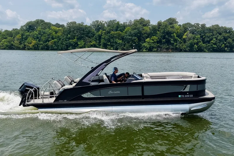 Slide: The Image of 2025 Barletta Lusso 25UCA pontoon boat cruising on a scenic lake. - 4