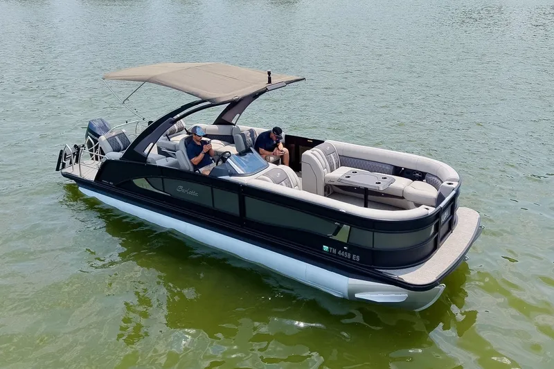 Slide: The Image of 2025 Barletta Lusso 25UCA pontoon boat cruising on a serene lake. - 50