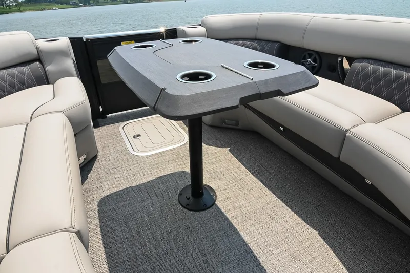 Slide: The Image of Luxurious seating area on 2025 Barletta Lusso 25UCA pontoon boat with table and cup holders. - 47