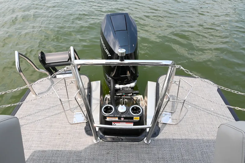 Slide: The Image of 2025 Barletta Lusso 25UCA pontoon boat with Mercury outboard motor on a lake. - 11