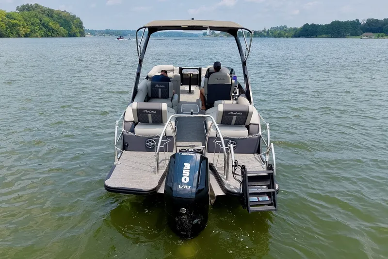 Slide: The Image of 2025 Barletta Lusso 25UCA pontoon boat on a serene lake, featuring a powerful outboard motor. - 56