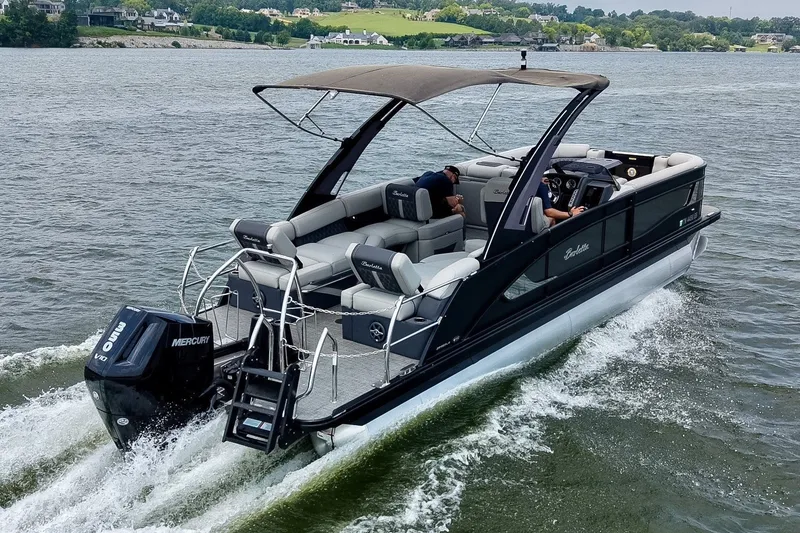 Slide: The Image of 2025 Barletta Lusso 25UCA pontoon boat cruising on a scenic lake. - 2