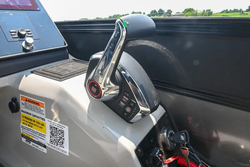 Slide: The Image of Control panel of 2025 Barletta Lusso 25UCA boat with throttle and warning labels. - 27