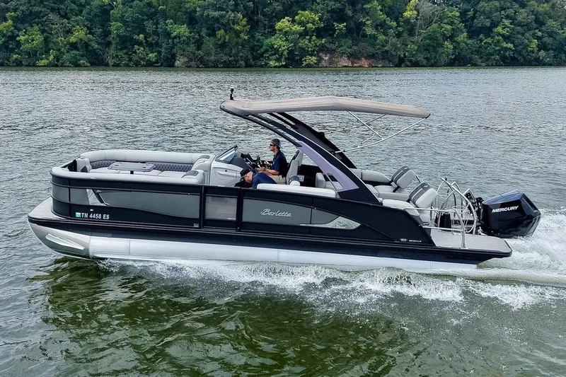 Slide: The Image of 2025 Barletta Lusso 25UCA pontoon boat cruising on a scenic river. - 3