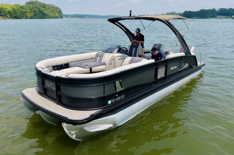 Slide: The Image of 2025 Barletta Lusso 25UCA pontoon boat on a serene lake with lush green shoreline. - 52