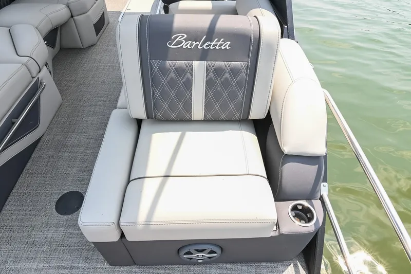 Slide: The Image of Luxurious seating on 2025 Barletta Lusso 25UCA pontoon boat, featuring elegant upholstery and cup holder. - 38
