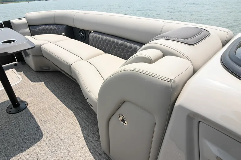Slide: The Image of Luxurious seating on 2025 Barletta Lusso 25UCA pontoon boat, featuring elegant upholstery and lake view. - 42