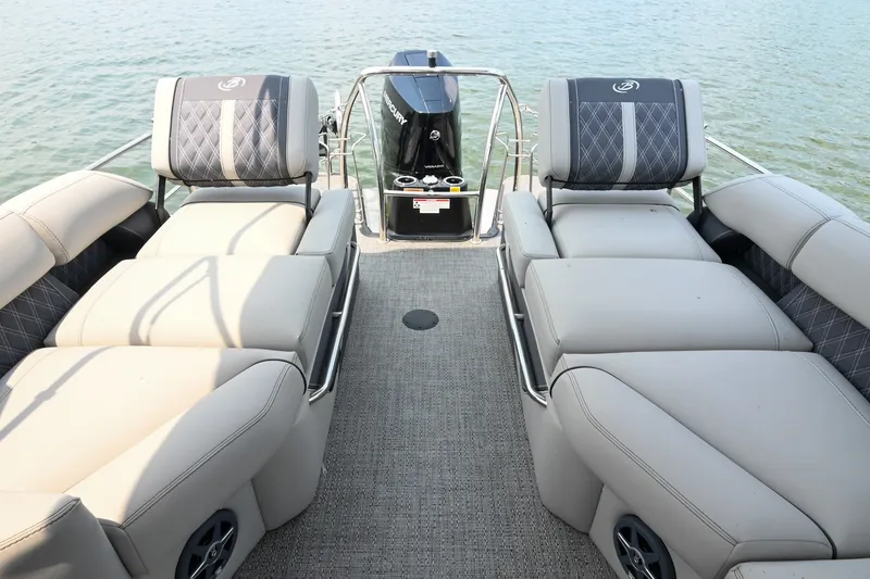 Slide: The Image of 2025 Barletta Lusso 25UCA pontoon boat interior with luxurious seating on calm water. - 30