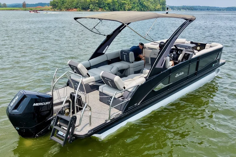Slide: The Image of 2025 Barletta Lusso 25UCA pontoon boat on a lake, featuring a Mercury engine. - 57