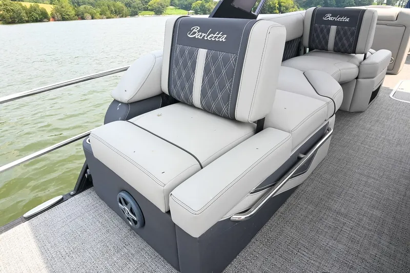 Slide: The Image of Luxurious seating on 2025 Barletta Lusso 25UCA pontoon boat, featuring elegant upholstery and lake view. - 37