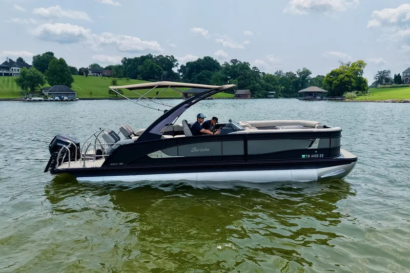 Slide: The Image of 2025 Barletta Lusso 25UCA pontoon boat cruising on a scenic lake. - 48