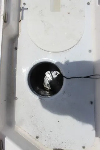 Slide: The Image of A round, black inlet on a white boat deck with a cable leading out. - 48