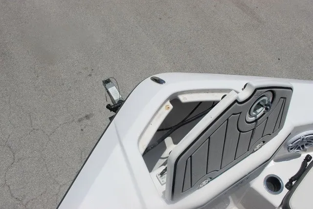 Slide: The Image of The image shows the bow of a 2021 Yamaha 210 FSH Sport boat with gray padding. - 50