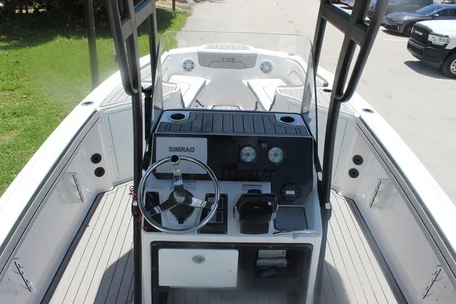 Slide: The Image of The image shows the cockpit of a 2021 Yamaha 210 FSH Sport boat with helm console and instruments. - 16