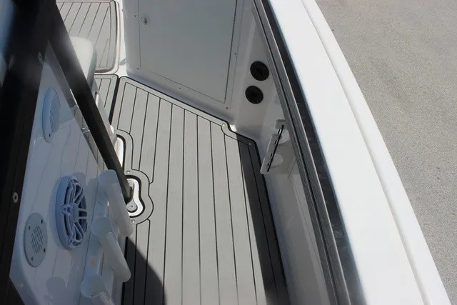 Slide: The Image of The image shows the deck of a Yamaha 210 FSH Sport boat with gray flooring. - 45