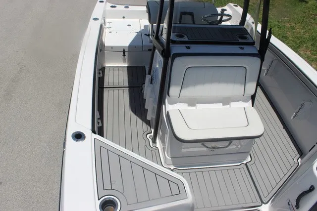 Slide: The Image of The image shows the deck of a 2021 Yamaha 210 FSH Sport boat with gray flooring. - 21