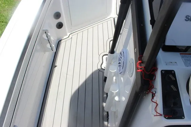 Slide: The Image of The image shows the deck of a Yamaha 210 FSH Sport boat with gray flooring. - 44