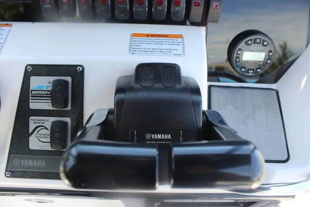 Slide: The Image of Close-up of a Yamaha 210 FSH Sport boat's helm with controls and gauges. - 33