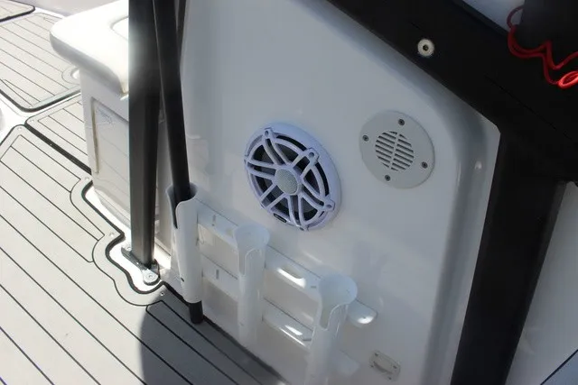 Slide: The Image of The image shows the deck of a Yamaha 210 FSH Sport boat with speakers and rod holders. - 35