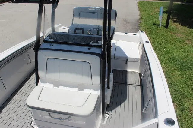 Slide: The Image of The image shows the cockpit of a 2021 Yamaha 210 FSH Sport boat with white seating. - 24