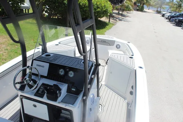 Slide: The Image of The image shows the cockpit of a 2021 Yamaha 210 FSH Sport boat with steering console and seating. - 17