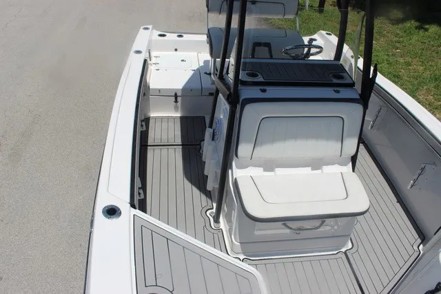 Slide: The Image of The image shows the cockpit of a 2021 Yamaha 210 FSH Sport boat with gray flooring. - 20