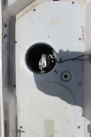 Slide: The Image of Close-up of a white boat deck with a circular opening and a cable. - 47