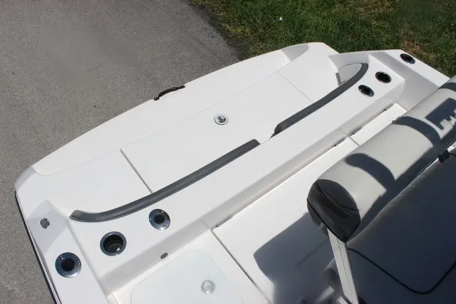 Slide: The Image of The image shows the stern of a 2021 Yamaha 210 FSH Sport boat with seating and cup holders. - 43