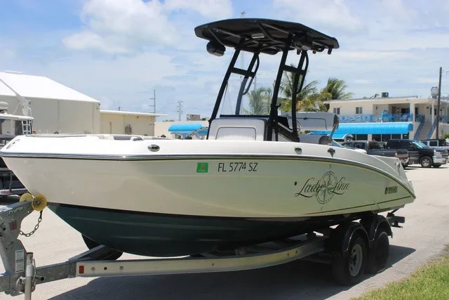 Slide: The Image of Yamaha 210 FSH Sport 2021 on a trailer, featuring a T-top and coastal background. - 12
