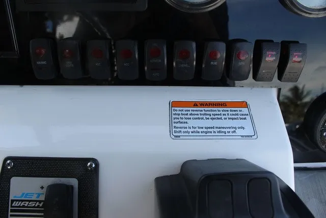 Slide: The Image of Close-up of the control panel with switches and a warning label. - 32