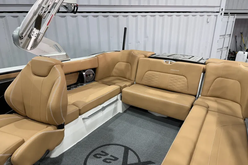 Slide: The Image of 2020 MasterCraft X22 boat interior with tan leather seating and modern design. - 12