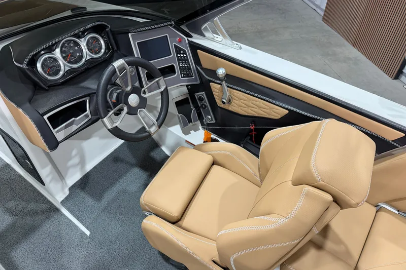 Slide: The Image of 2020 MasterCraft X22 boat interior with tan leather seats and modern dashboard controls. - 10
