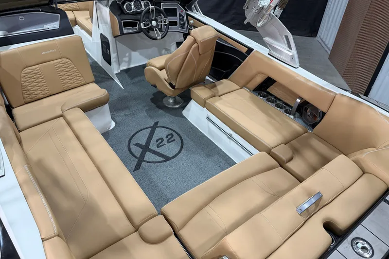 Slide: The Image of 2020 MasterCraft X22 boat interior with tan leather seating and modern dashboard. - 8