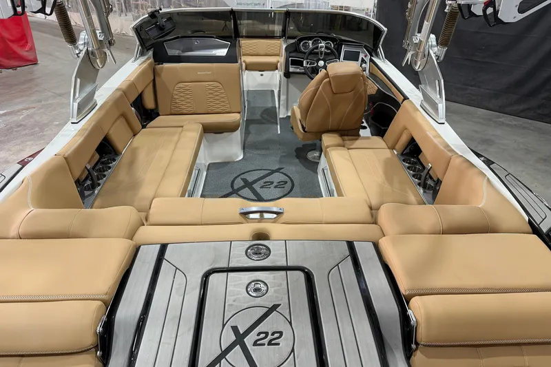 Slide: The Image of 2020 MasterCraft X22 boat interior with tan seating and modern dashboard. - 6