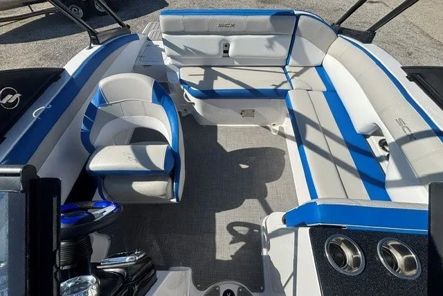 Slide: The Image of 2017 Starcraft SCX Surf 211 IO boat interior with blue and white seating. - 26