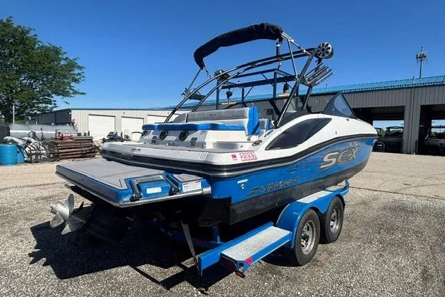 Slide: The Image of 2017 Starcraft SCX Surf 211 IO boat on trailer, parked outdoors. - 28
